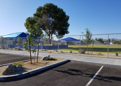 school fence at ullom elementary school with upgraded landscaping including decorative rocks and nursery trees