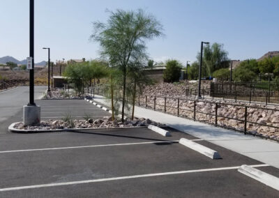 parking lot of dig park at fire station 85 in clark county Nevada with rock gardens and drainage system