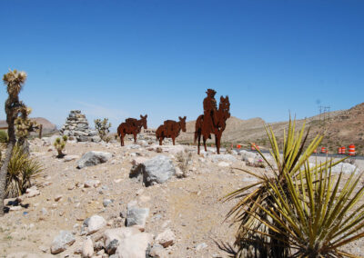 metal cowboy and donkeys installed at late night trailhead in las vegas nevada